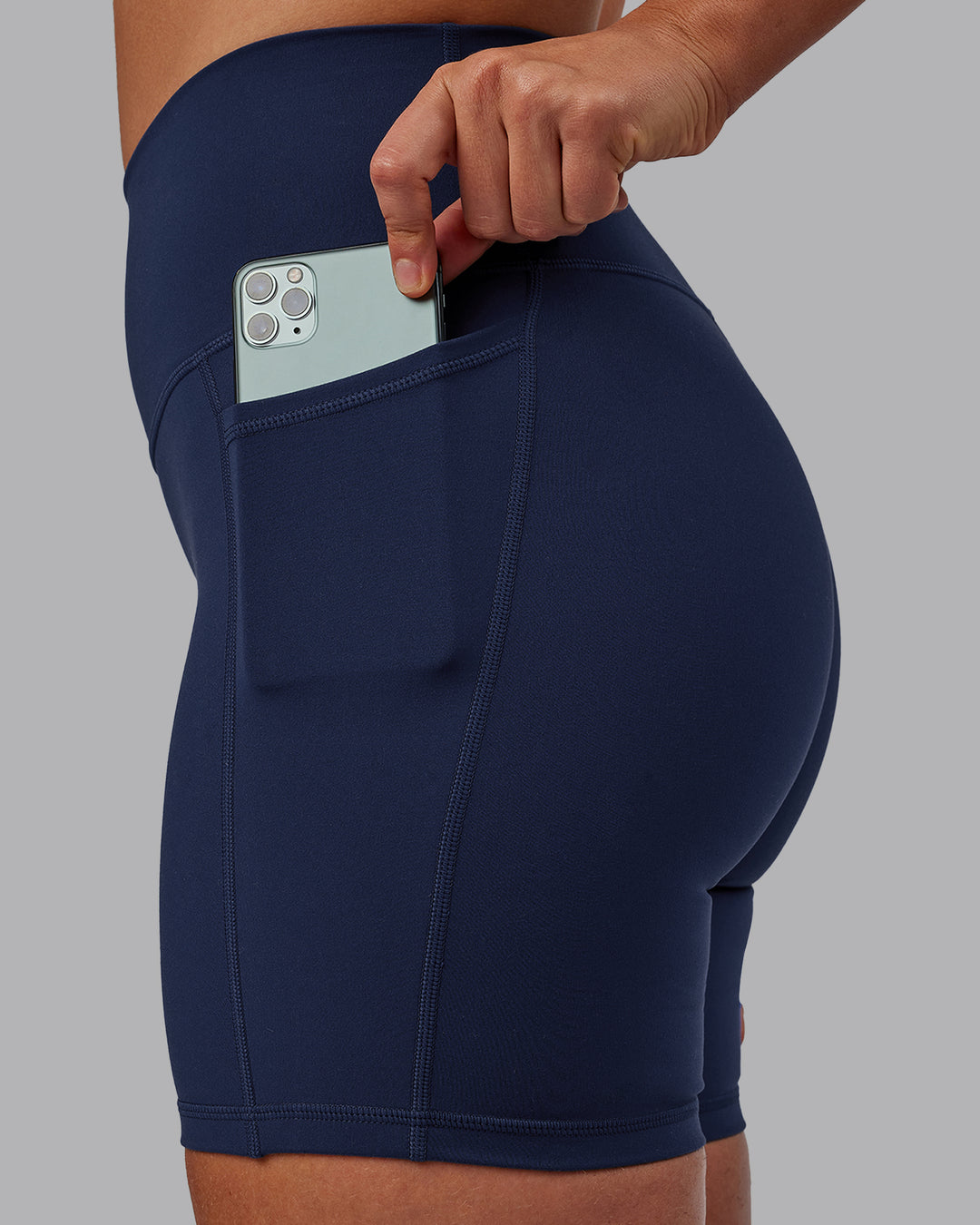 Woman wearing Fusion Mid Short Tights with Pockets - Future Navy