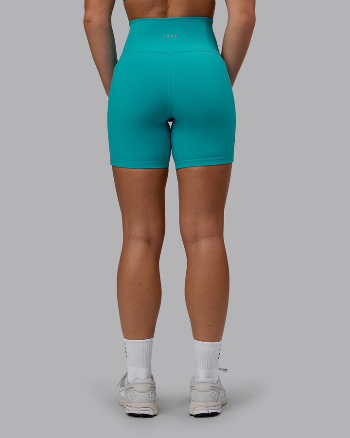 Woman wearing Fusion Mid Short Tights - Uplift Blue
