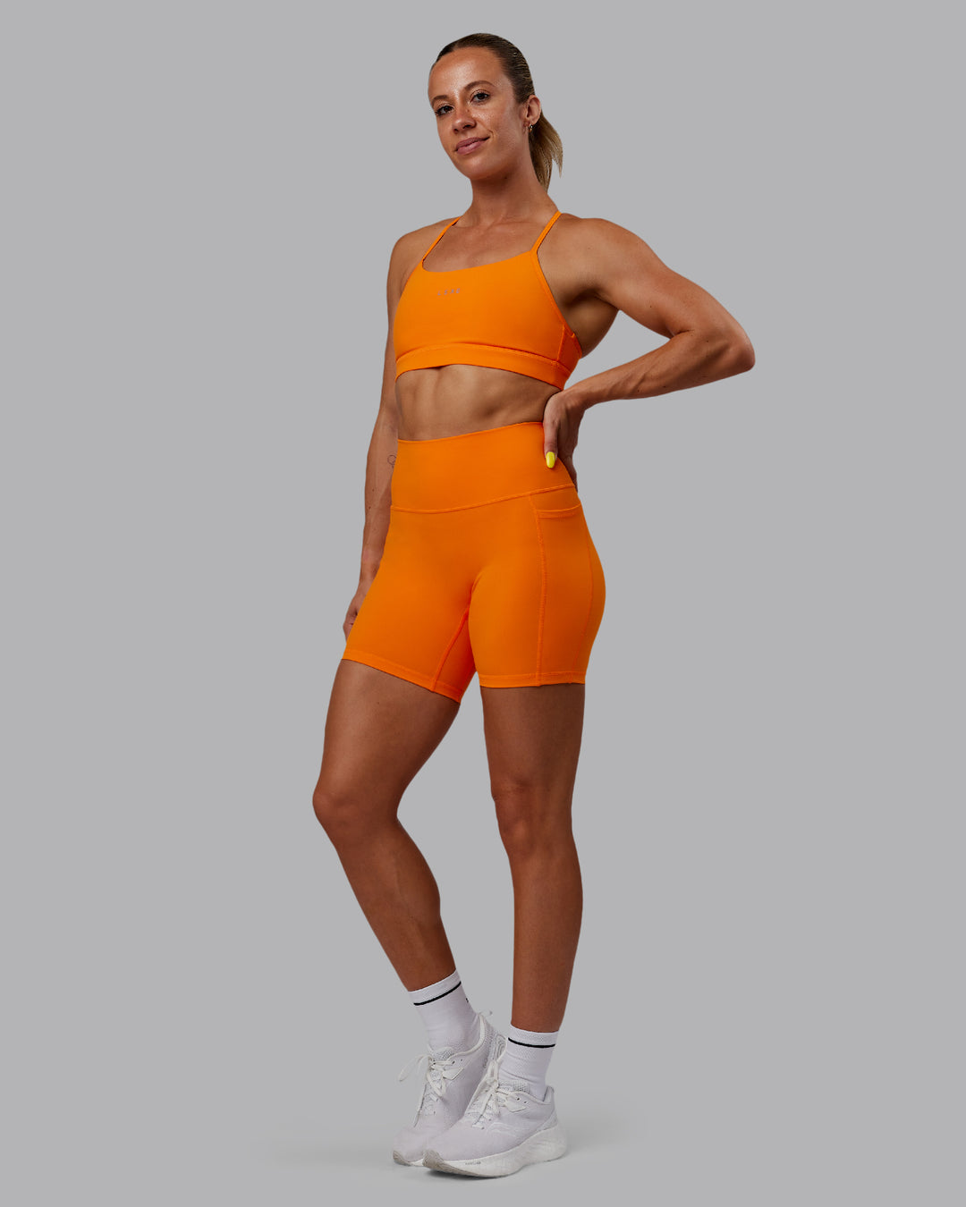 Woman wearing Fusion Mid Short Tights - Vibrant Orange