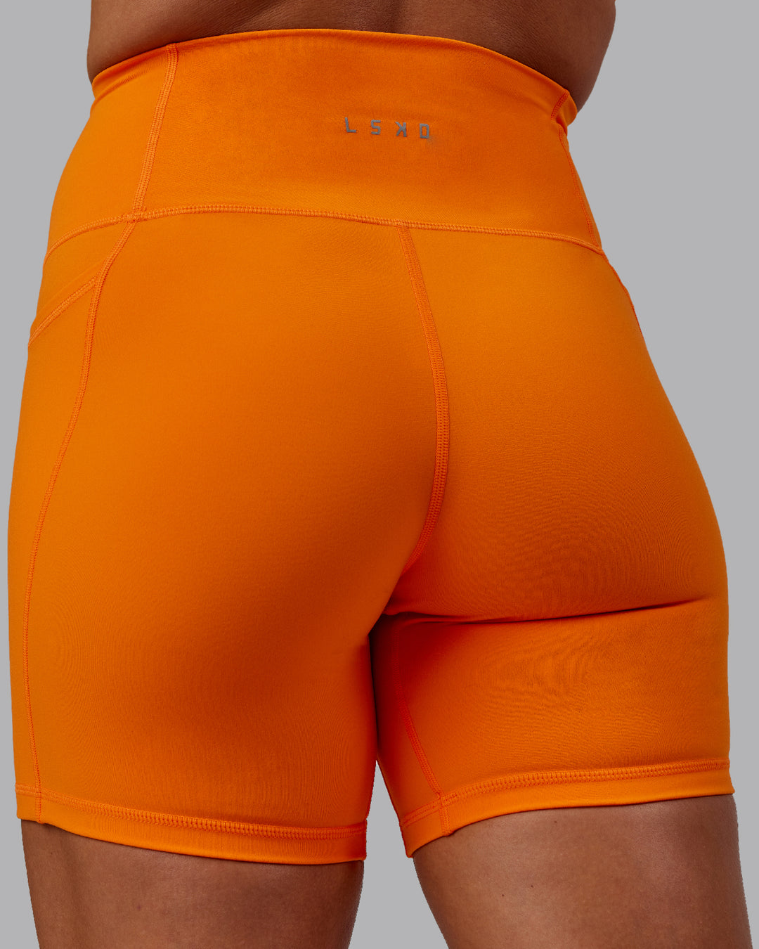 Woman wearing Fusion Mid Short Tights - Vibrant Orange