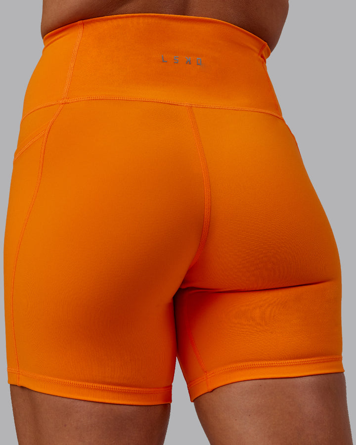 Woman wearing Fusion Mid Short Tights - Vibrant Orange
