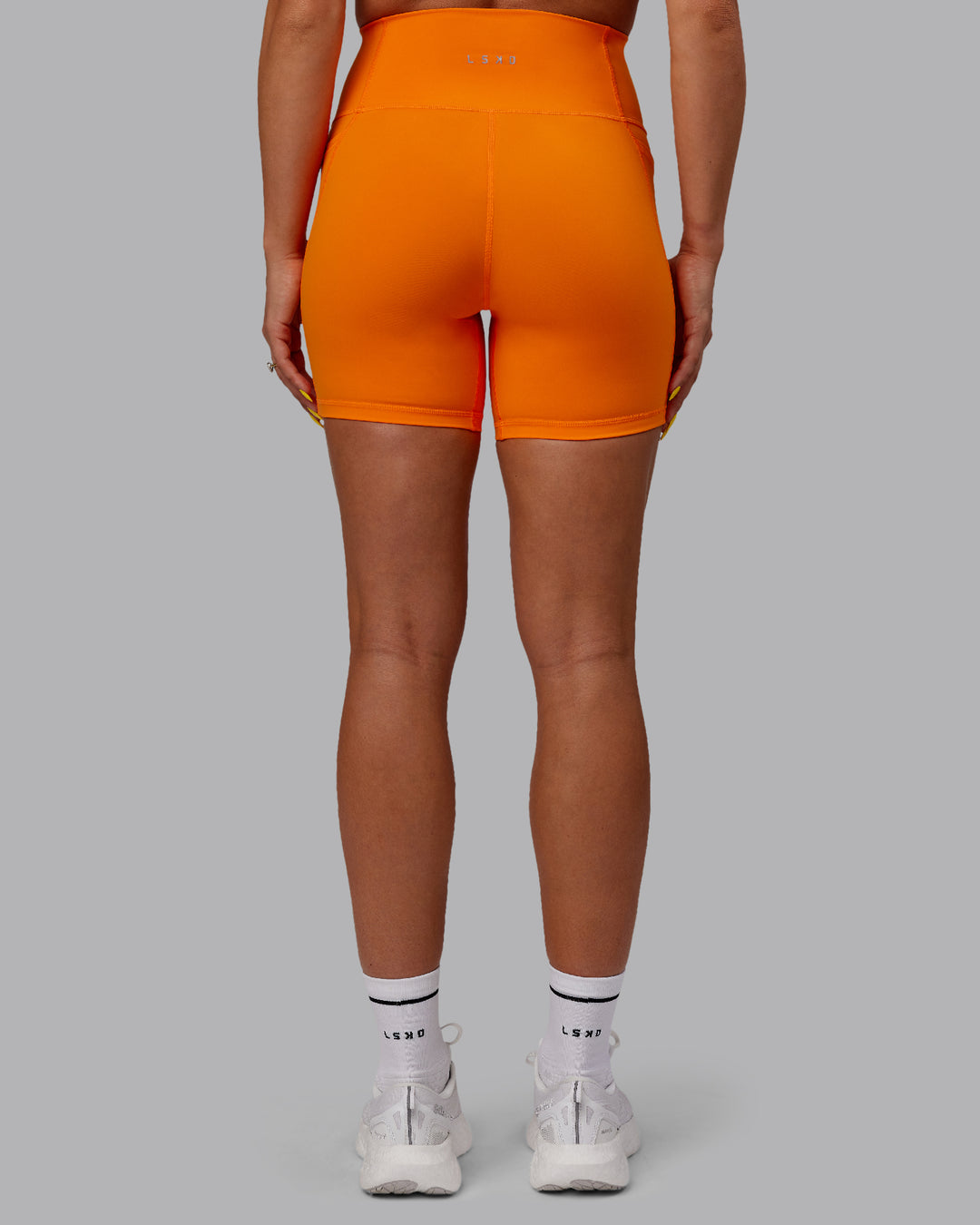 Woman wearing Fusion Mid Short Tights - Vibrant Orange