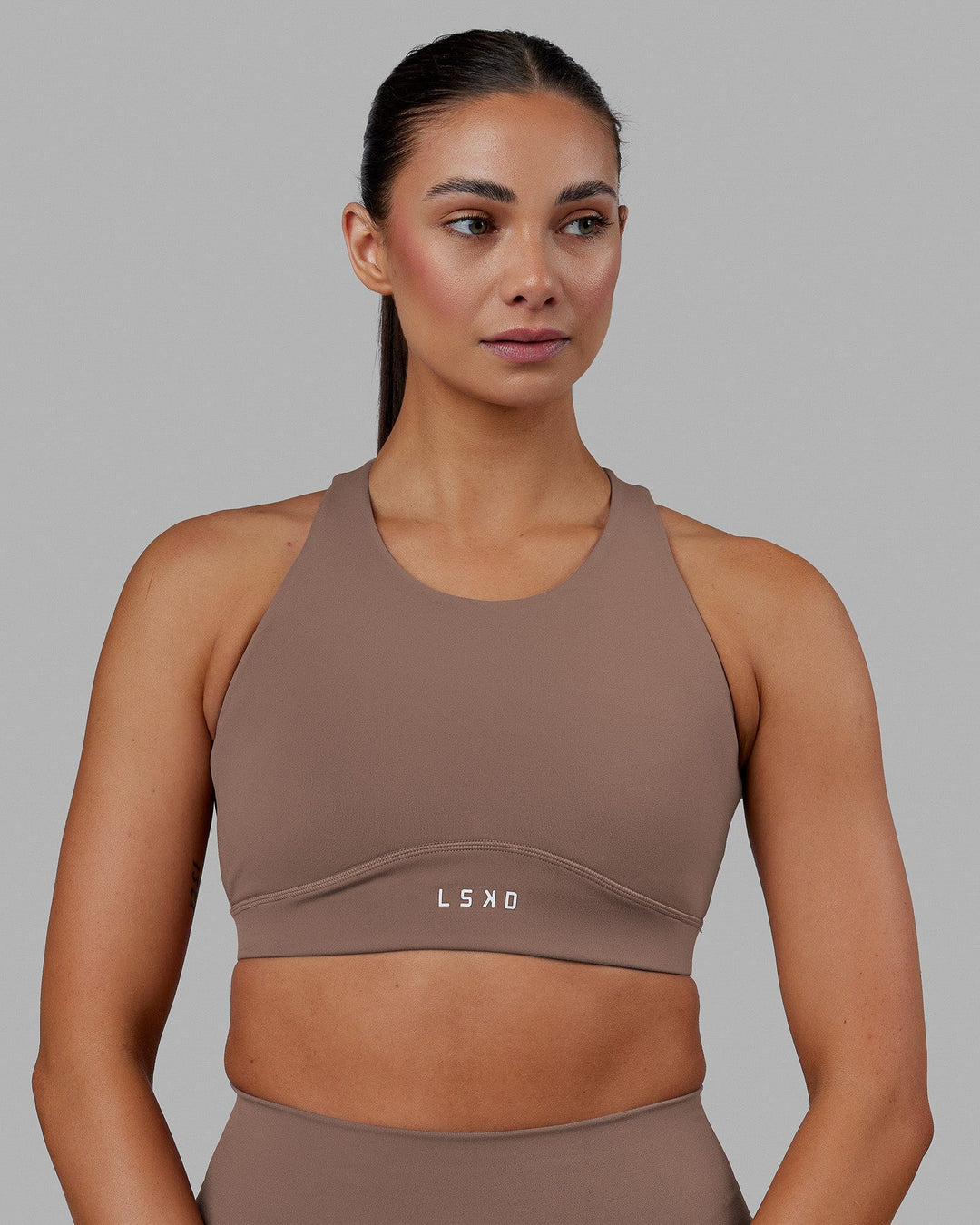 Woman wearing Fusion Sports Bra - Deep Taupe