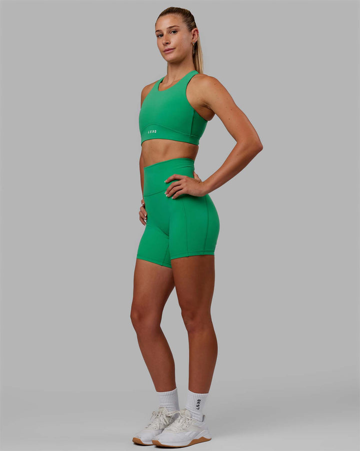 Woman wearing Fusion Sports Bra - Holly Green
