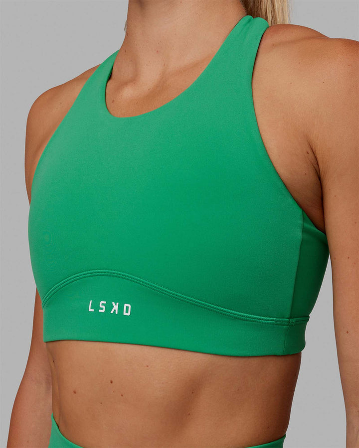 Woman wearing Fusion Sports Bra - Holly Green
