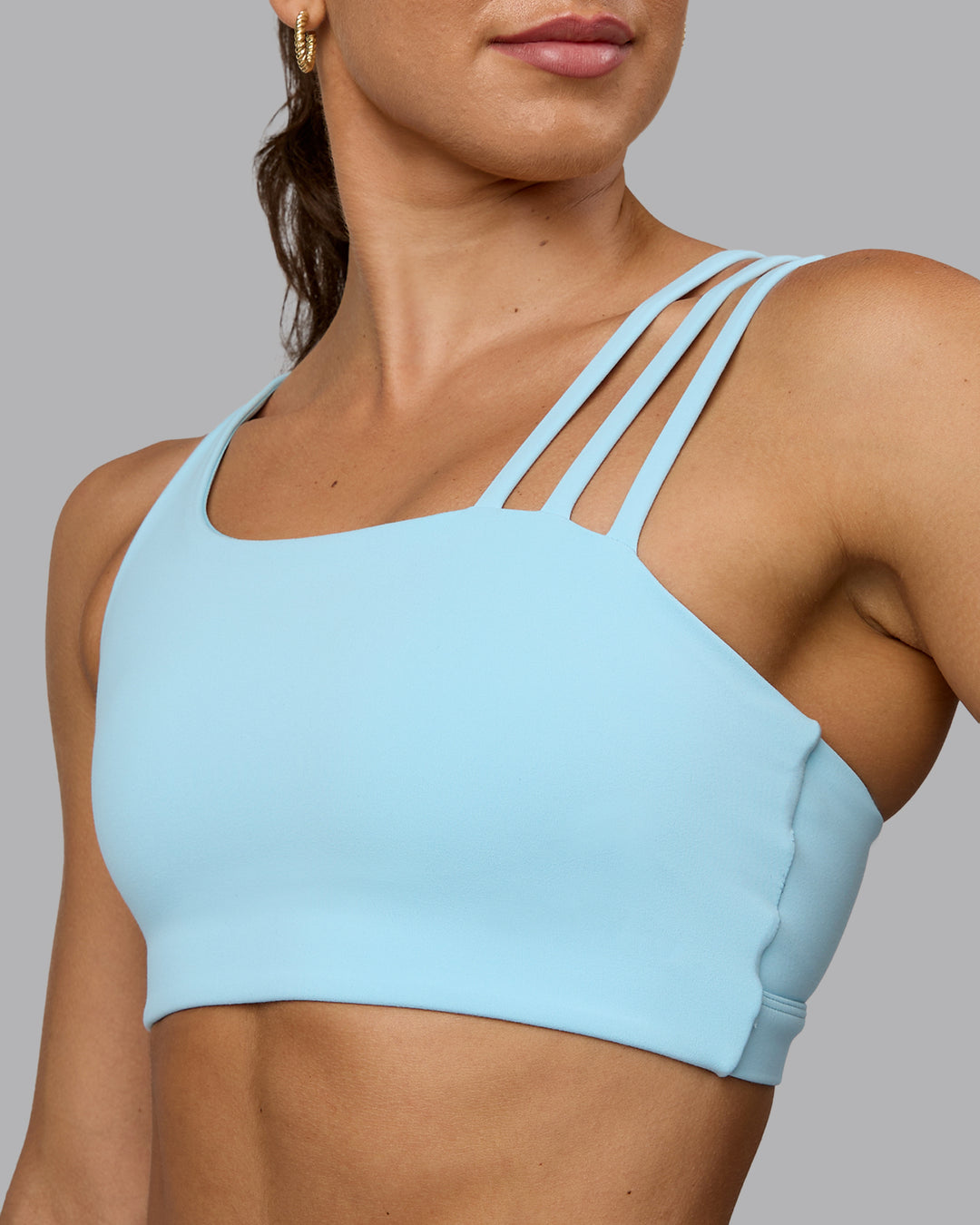 Woman wearing Galvanise Sports Bra - Crystal Blue