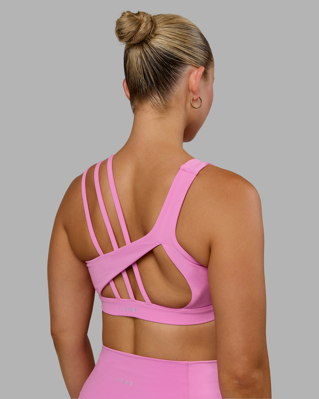 Woman wearing Galvanise Sports Bra - Spark Pink