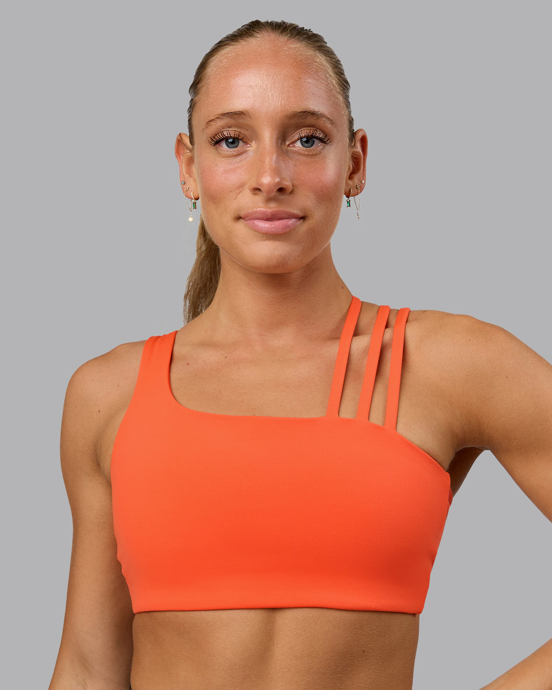 Woman wearing Galvanise Sports Bra - Ultra Orange