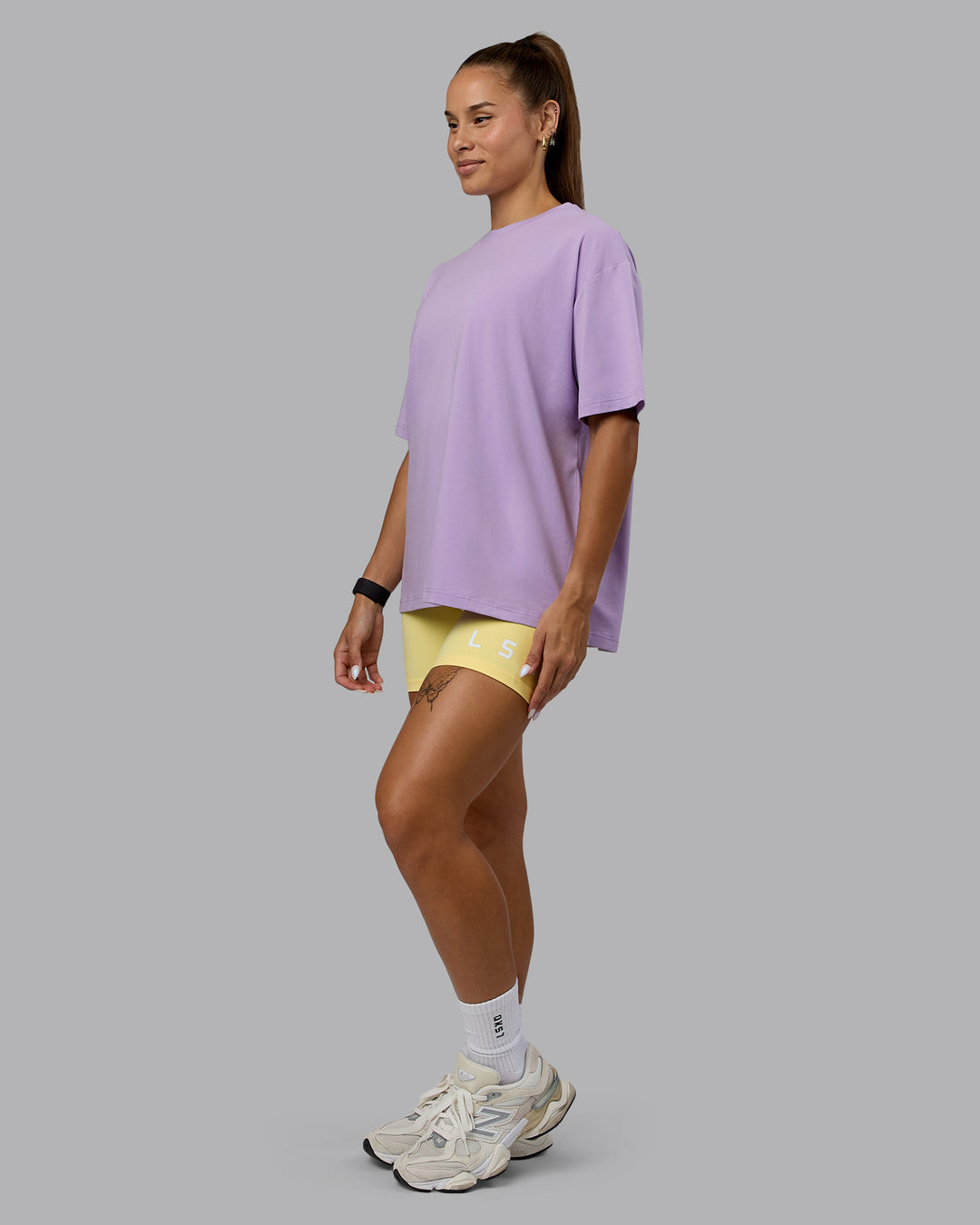 Woman wearing Go-To Set The Standard FLXCotton Oversized Tee - Pale Lilac-Elfin Yellow