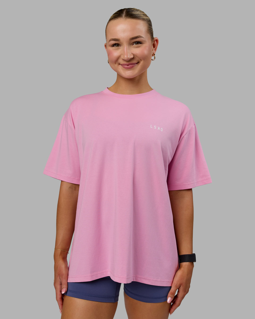 Woman wearing Go-To We Rise FLXCotton Oversized Tee - Bubblegum-White