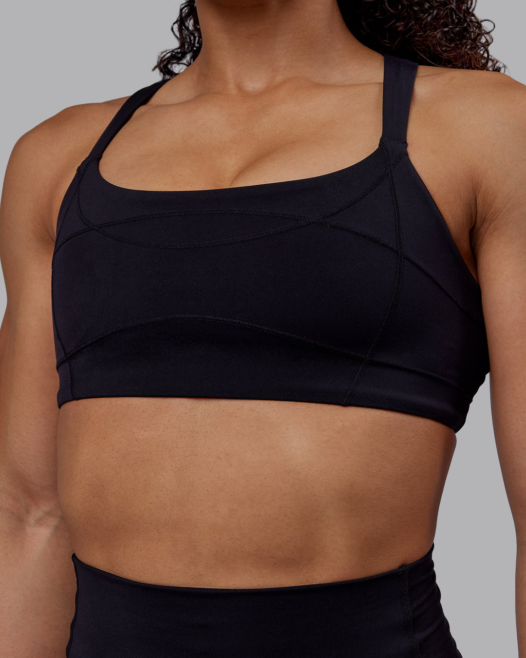 Woman wearing Inertia Sports Bra - Black