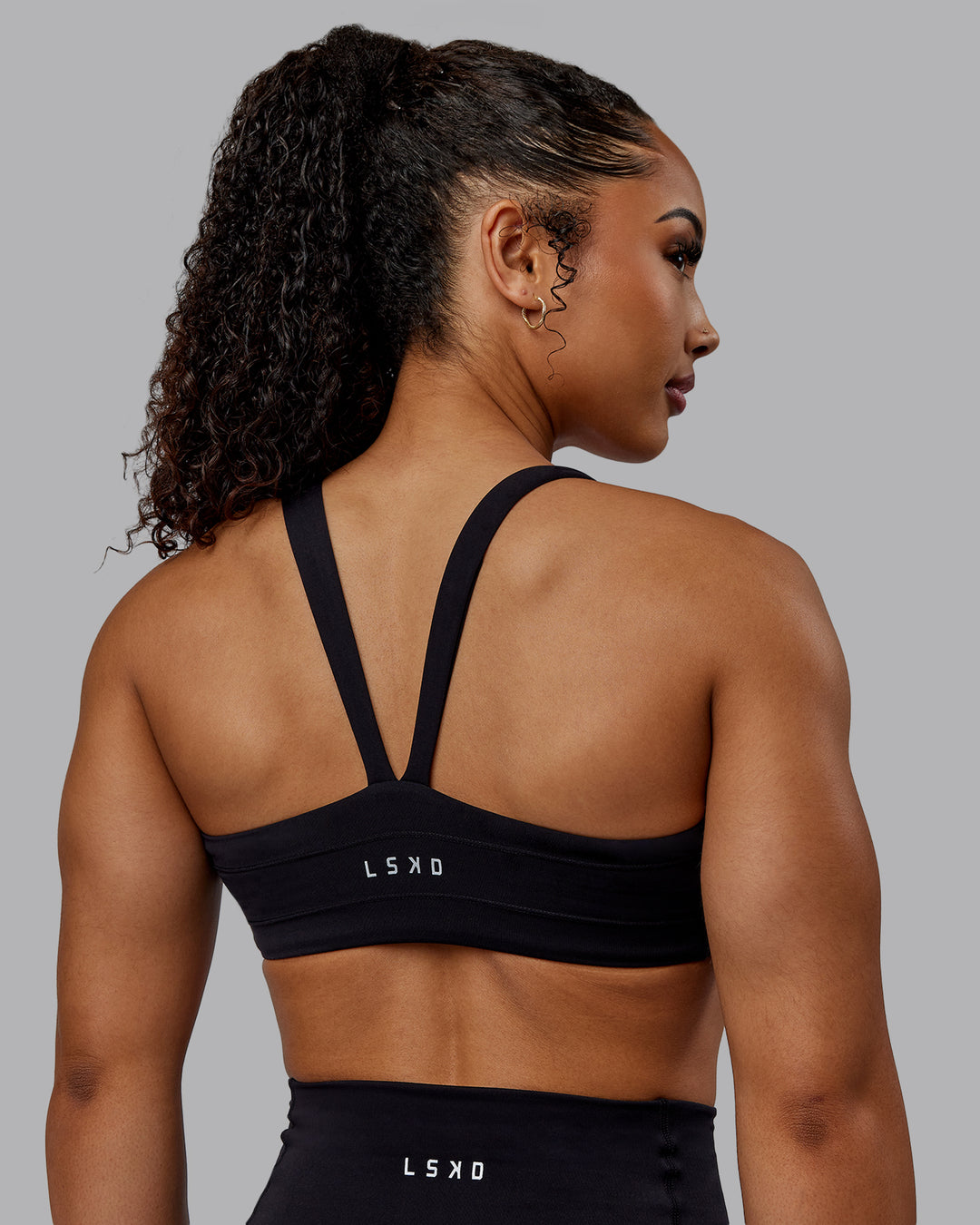 Woman wearing Inertia Sports Bra - Black