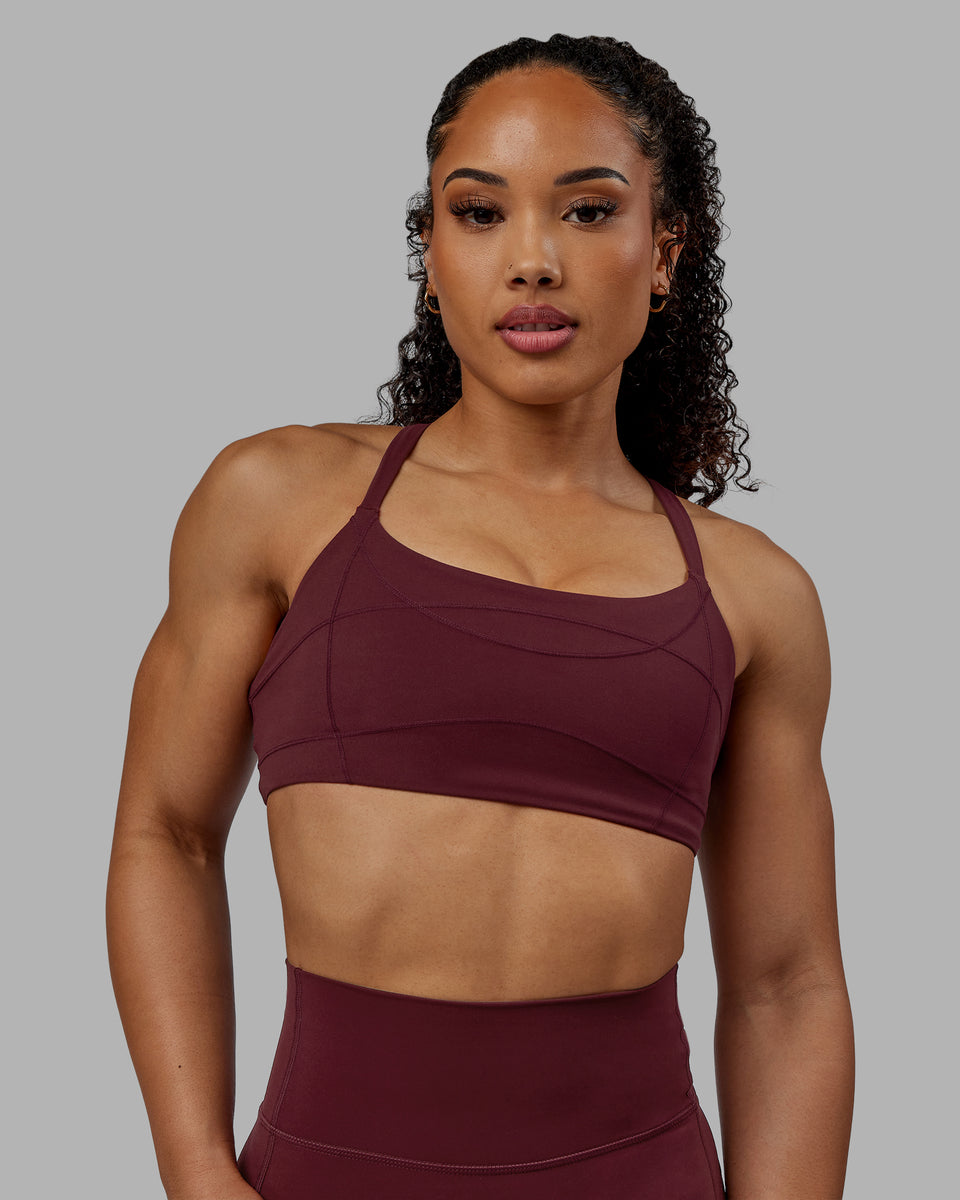 Woman wearing Inertia Sports Bra - Dark Cherry