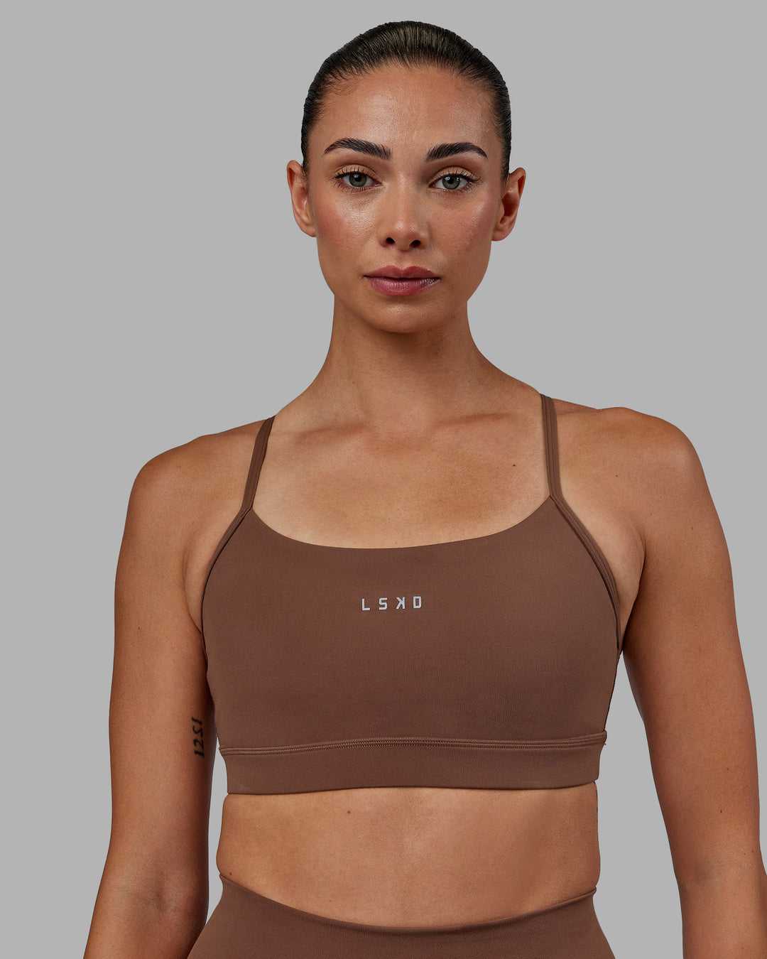 Woman wearing Lift Sports Bra - Dull Rust