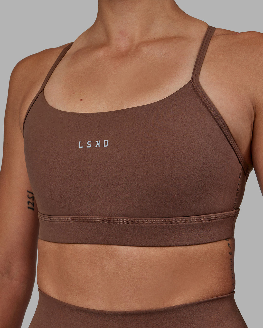 Woman wearing Lift Sports Bra - Dull Rust