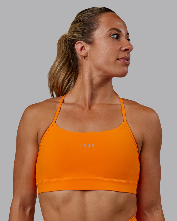 Woman wearing Lift Sports Bra - Vibrant Orange
