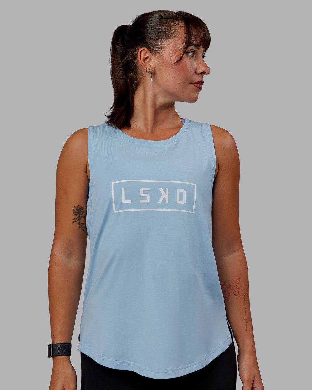 Woman wearing Luna FLXCotton Longline Tank - Glacial Blue-White