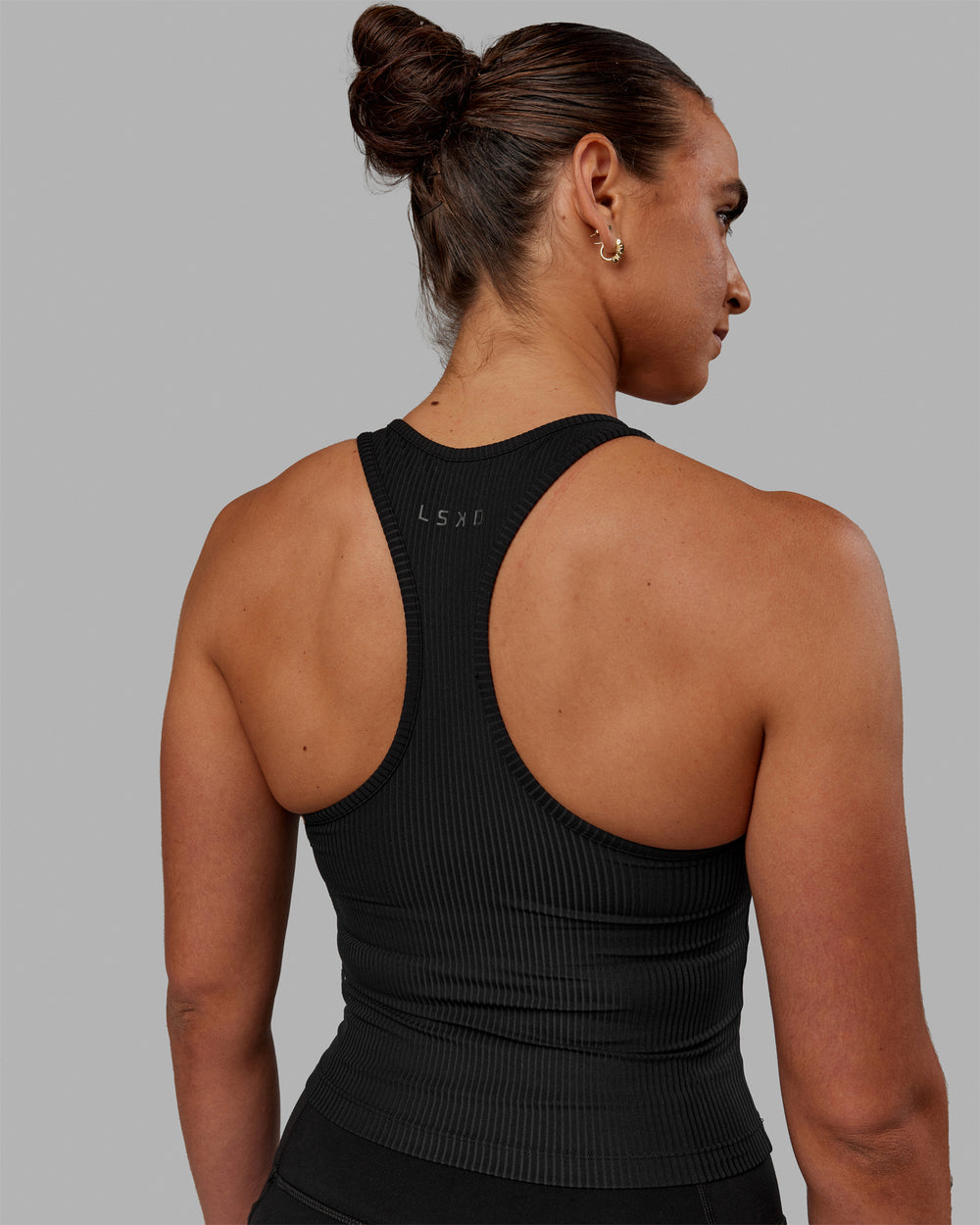 Woman wearing Luxe Ribbed Flow Shelf Bra Performance Tank - Black