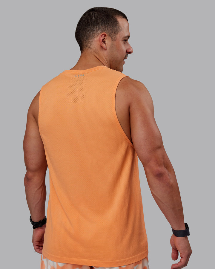 Man wearing AeroFLX+ Seamless Muscle Tank - Cantaloupe/Cantaloupe Marl
