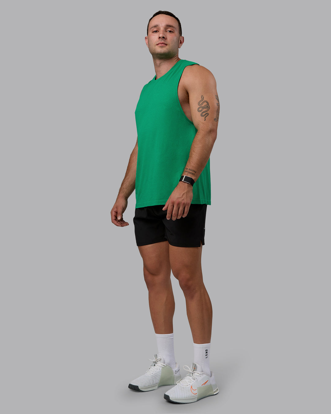 Man wearing AeroFLX+ Seamless Muscle Tank - Pepper Green/Impact Green