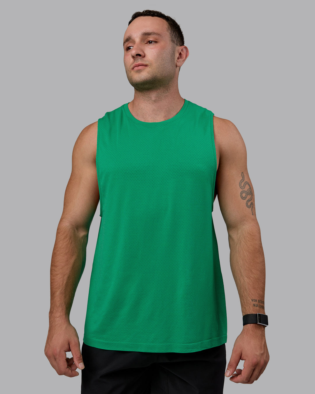 Man wearing AeroFLX+ Seamless Muscle Tank - Pepper Green/Impact Green