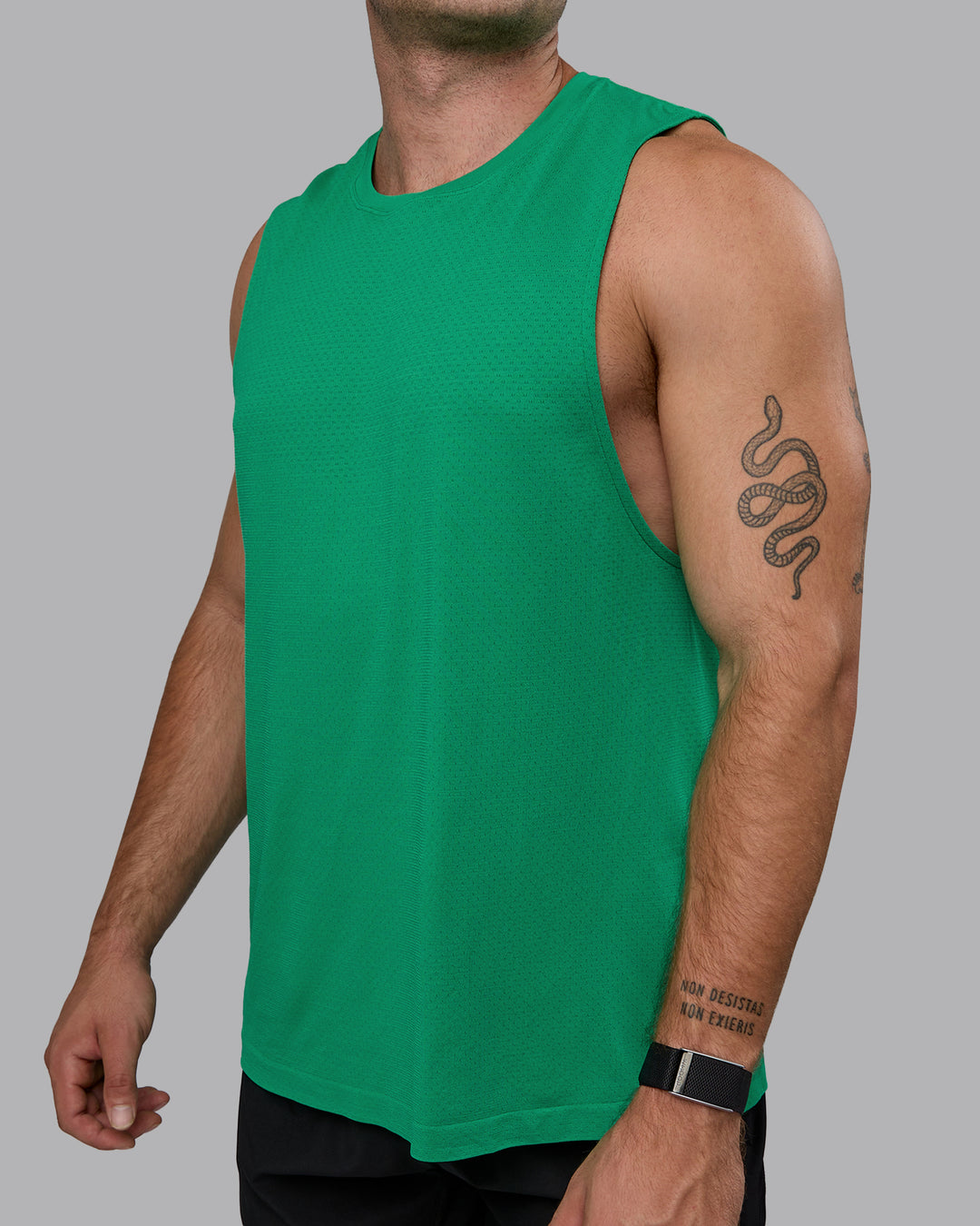 Man wearing AeroFLX+ Seamless Muscle Tank - Pepper Green/Impact Green