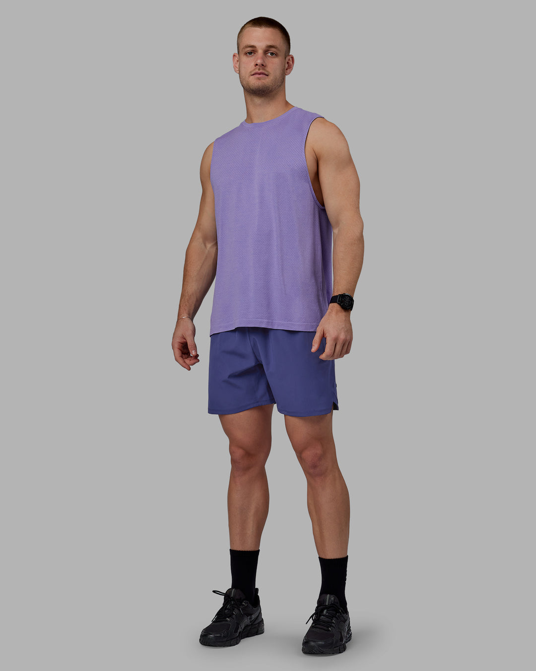 Man wearing AeroFLX+ Seamless Muscle Tank - Dahlia Purple Marl