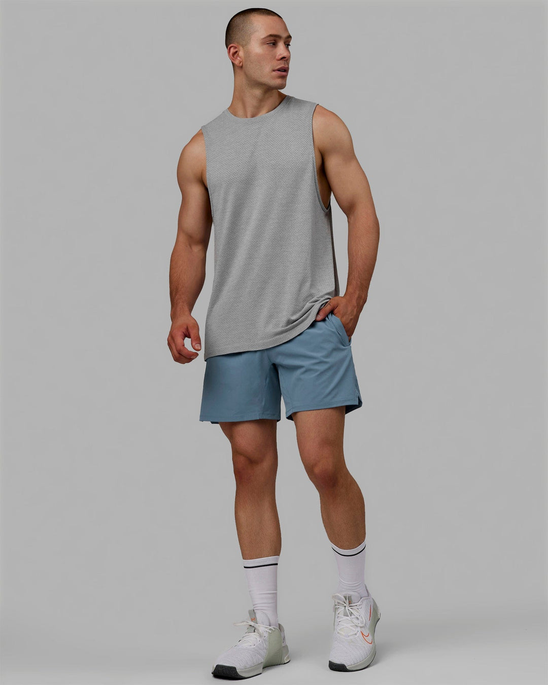 Man wearing AeroFLX+ Seamless Muscle Tank - Lt Grey Marl