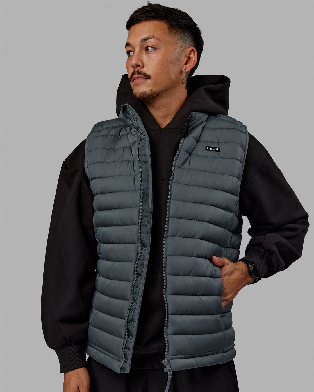 Man wearing All Day Puffer Vest - Storm