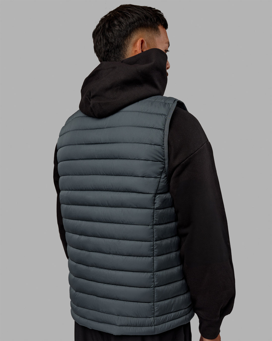 Man wearing All Day Puffer Vest - Storm