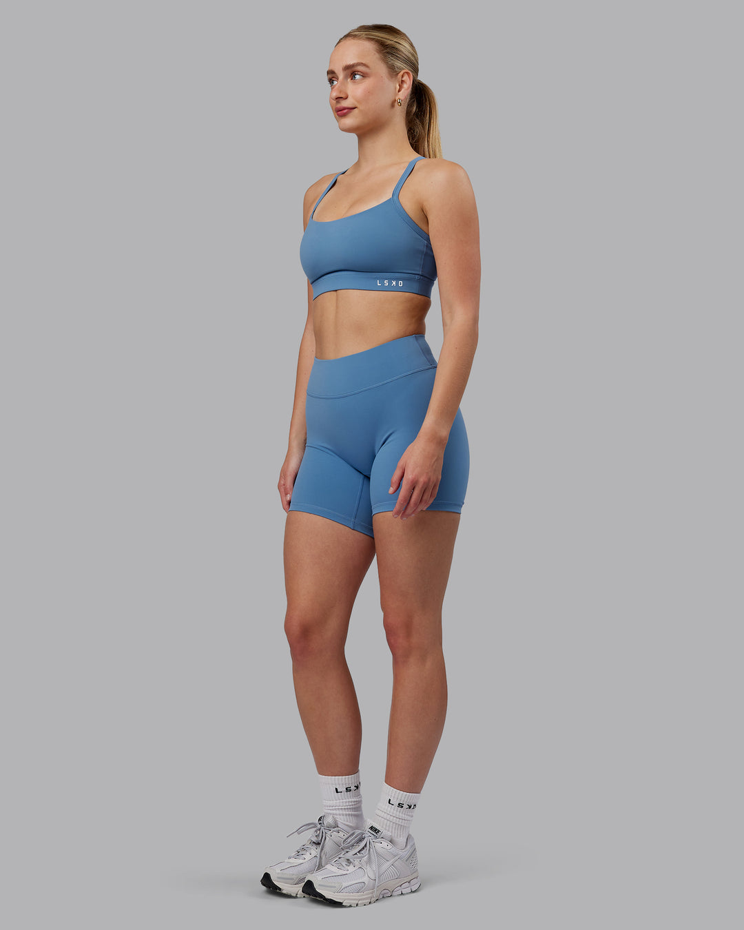 Woman wearing Momentum Sports Bra (D/DD/E) - Elemental Blue