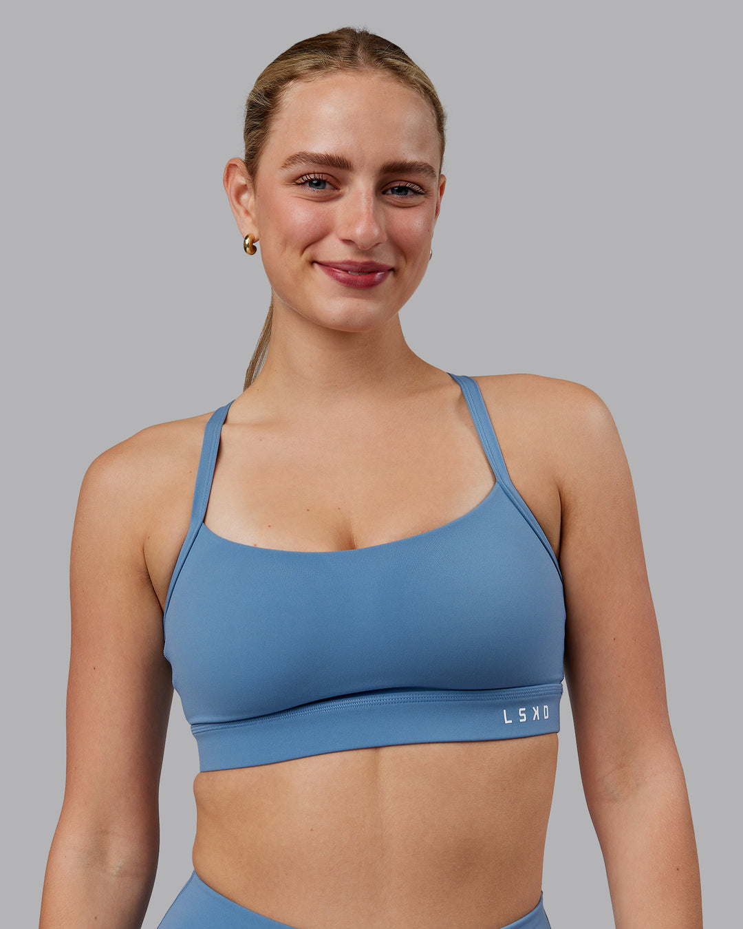 Woman wearing Momentum Sports Bra (D/DD/E) - Elemental Blue