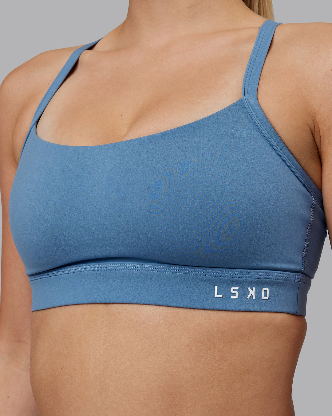 Woman wearing Momentum Sports Bra (D/DD/E) - Elemental Blue