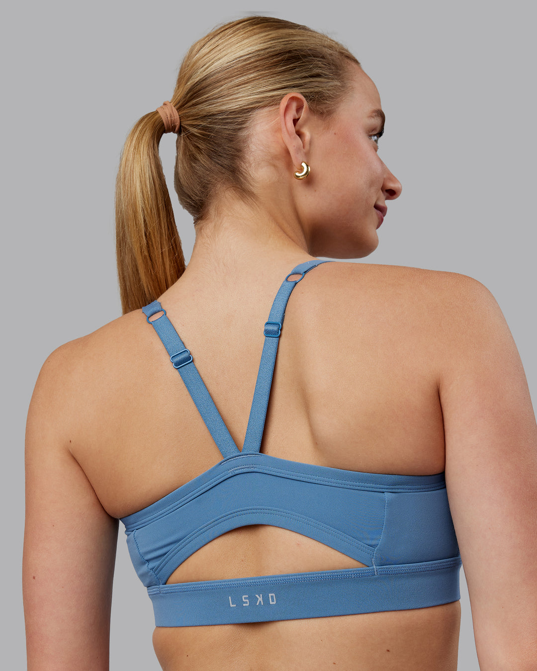 Woman wearing Momentum Sports Bra (D/DD/E) - Elemental Blue