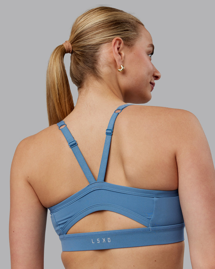 Woman wearing Momentum Sports Bra (D/DD/E) - Elemental Blue
