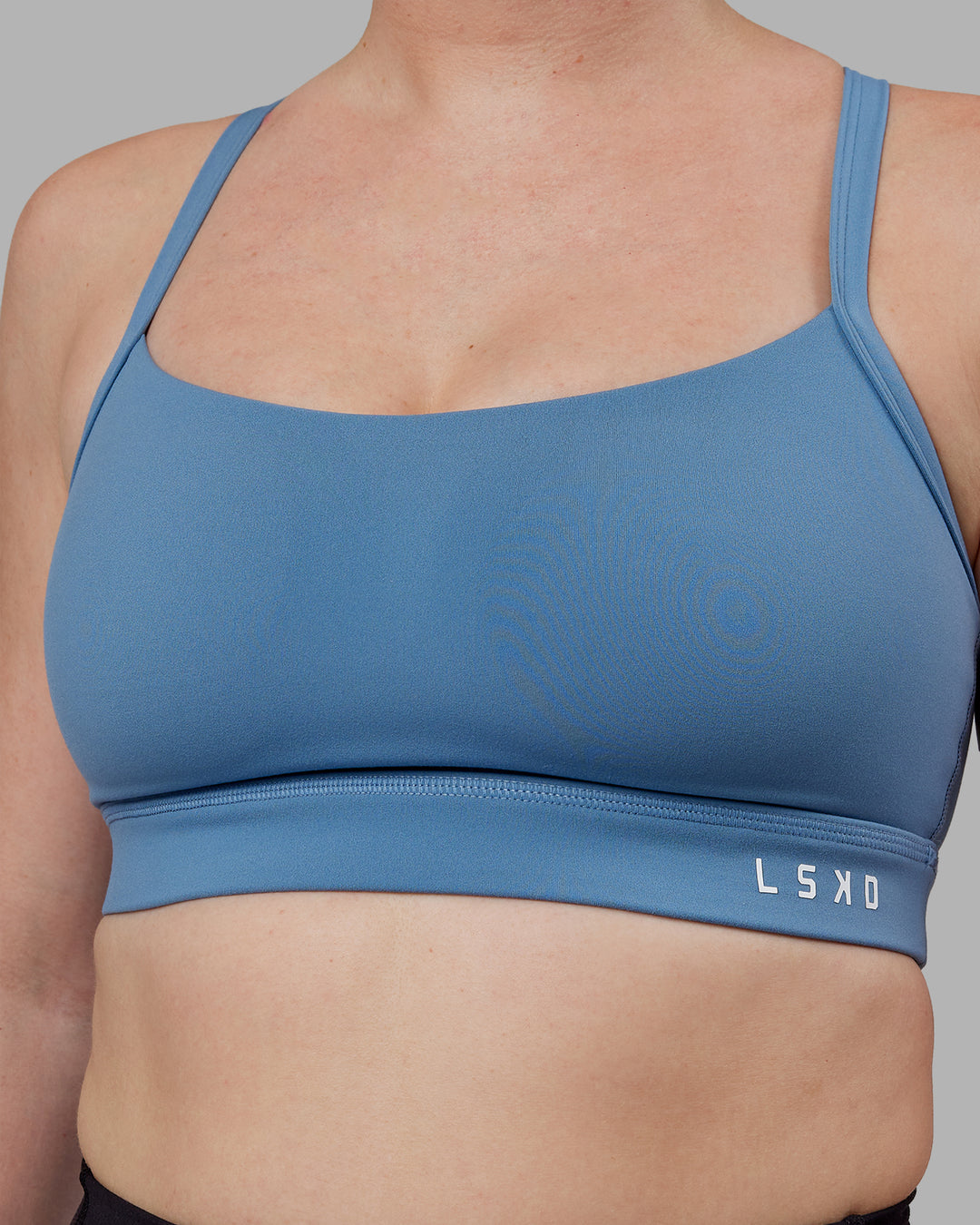 Woman wearing Momentum Sports Bra (D/DD/E) - Elemental Blue