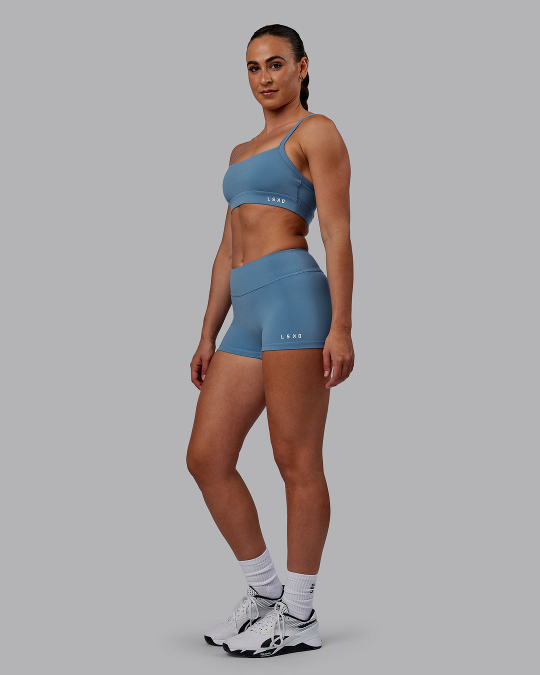 Woman wearing Momentum Sports Bra - Elemental Blue