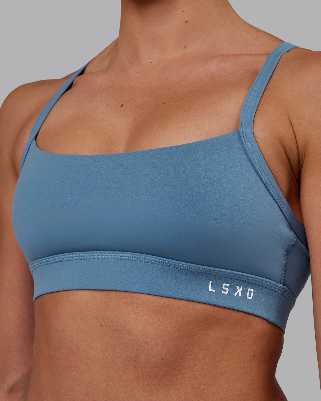 Woman wearing Momentum Sports Bra - Elemental Blue