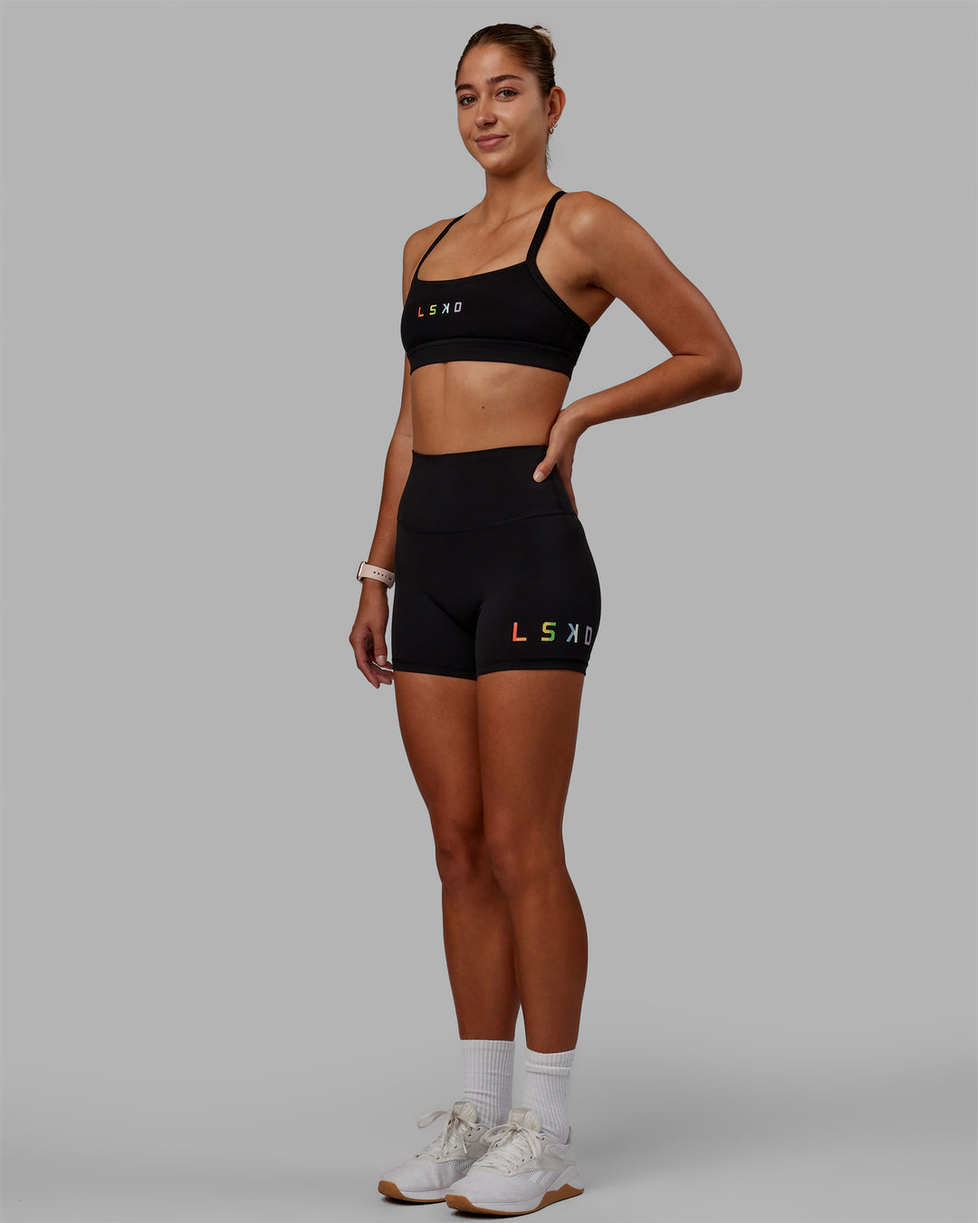 Woman wearing Momentum Sports Bra - Pride-Black