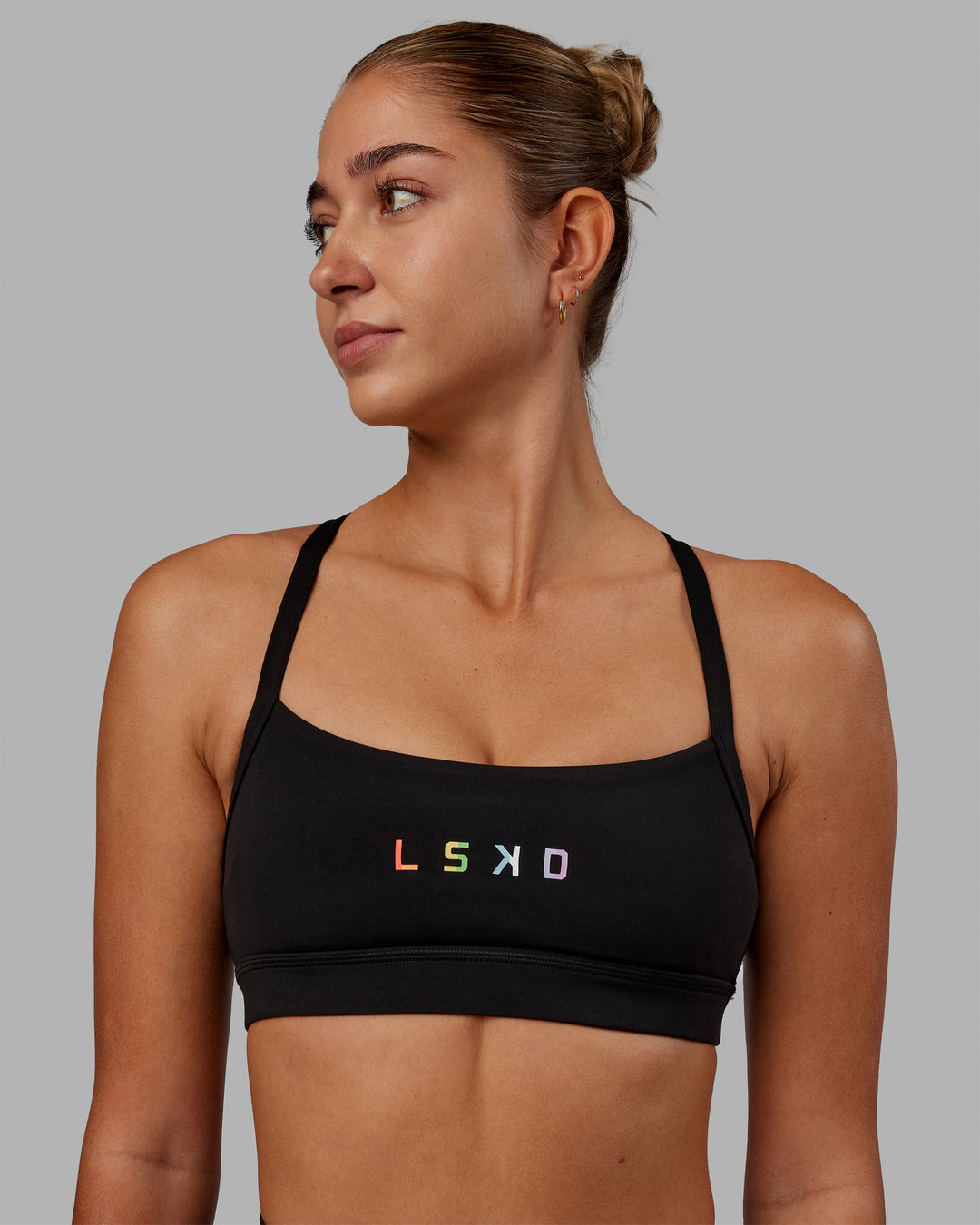 Woman wearing Momentum Sports Bra - Pride-Black