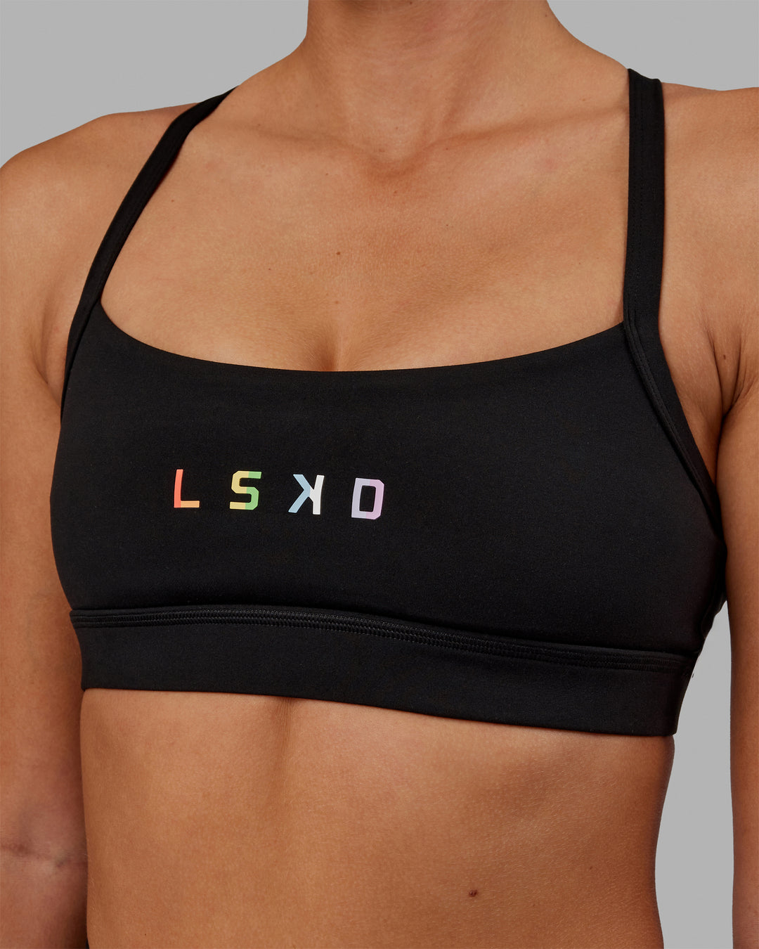 Woman wearing Momentum Sports Bra - Pride-Black