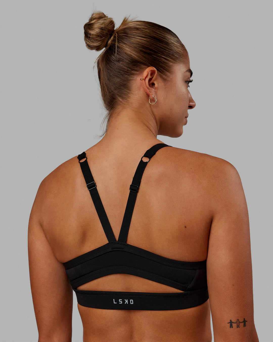 Woman wearing Momentum Sports Bra - Pride-Black