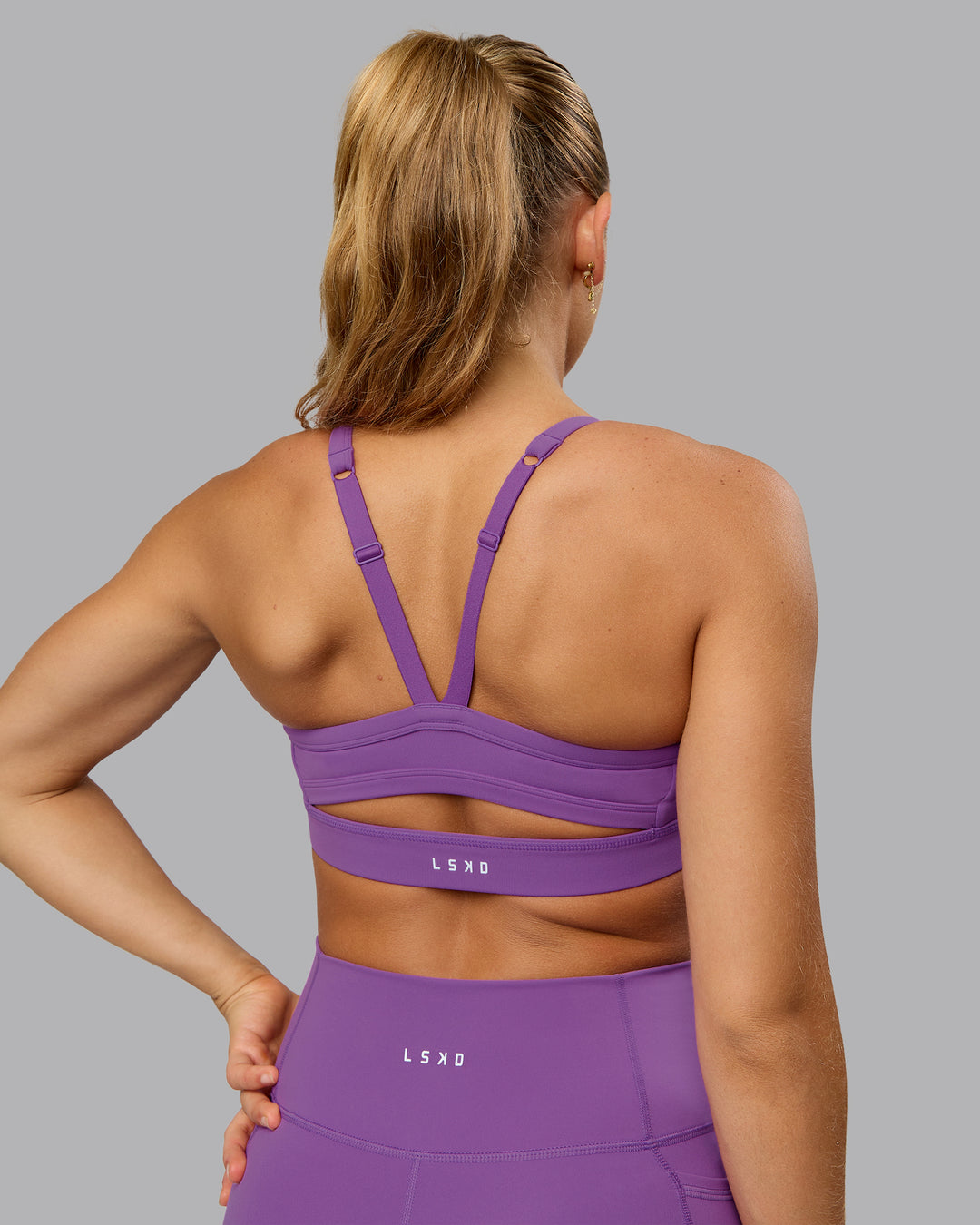 Woman wearing Momentum Sports Bra - Purple Fizz