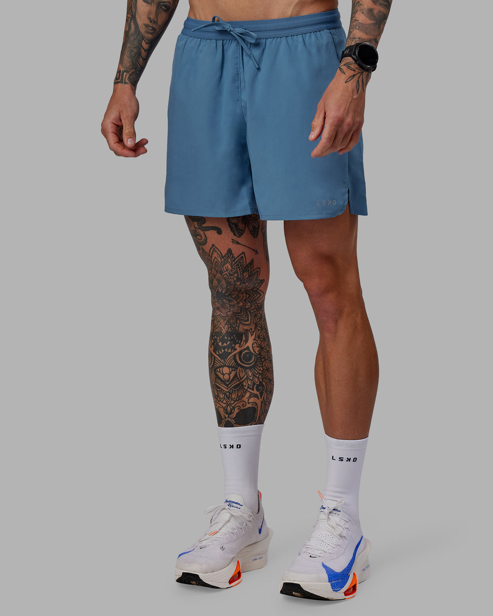 Man wearing Pace 5" Lined Performance Shorts - Elemental Blue