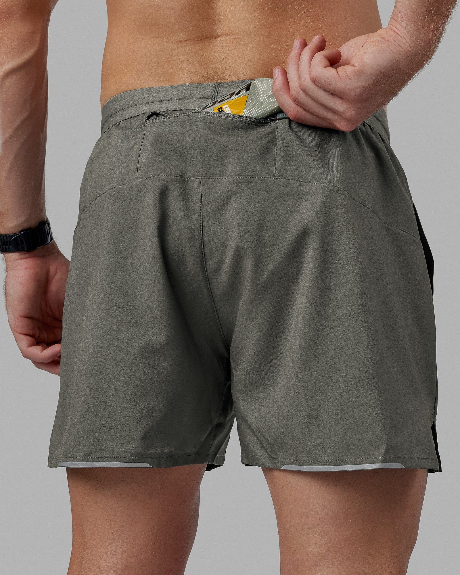 Man wearing Pace 5" Lined Performance Shorts - Graphite-Reflective