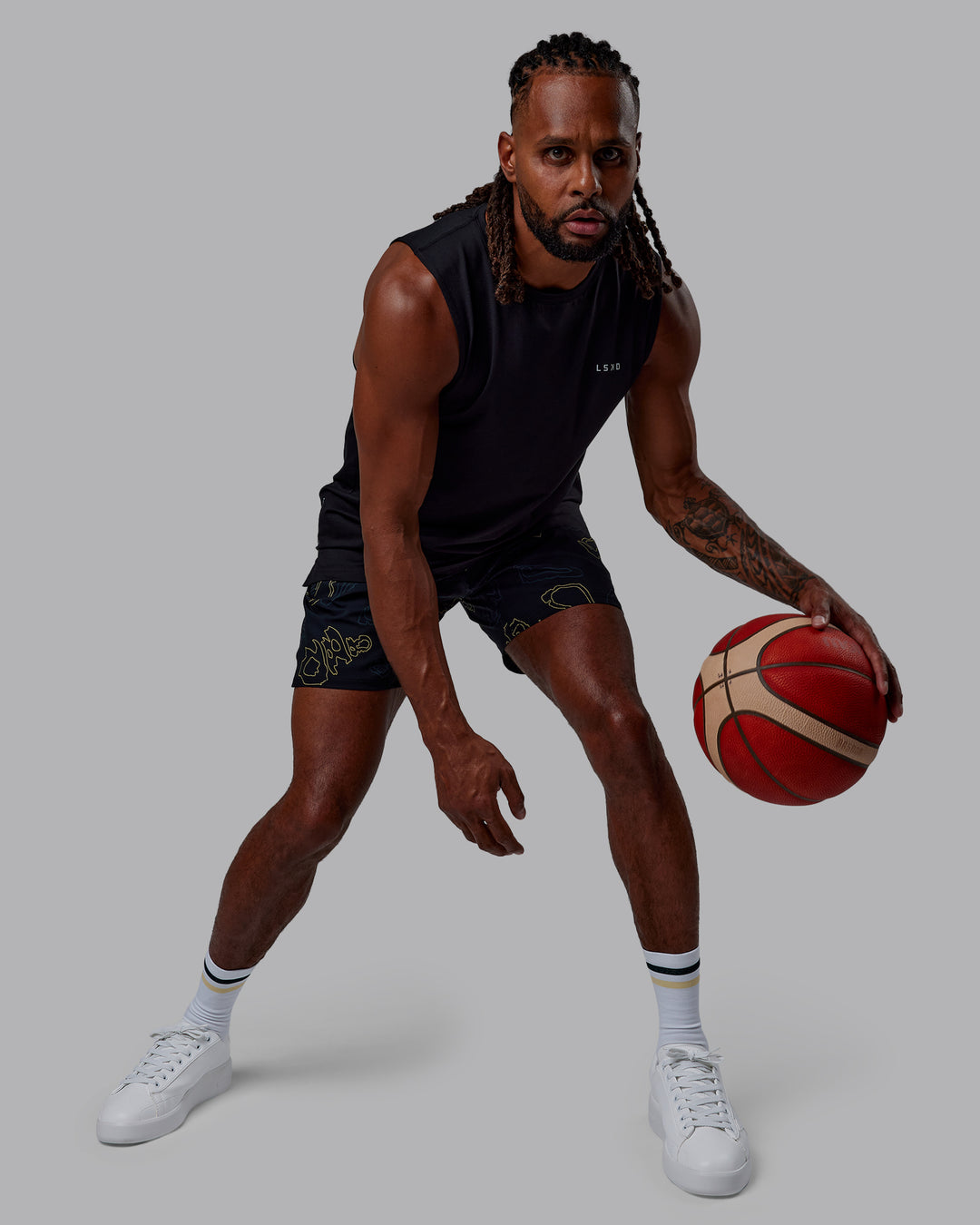 Man wearing Patty Mills Challenger 6&quot; Performance Shorts - Black-Vital Green