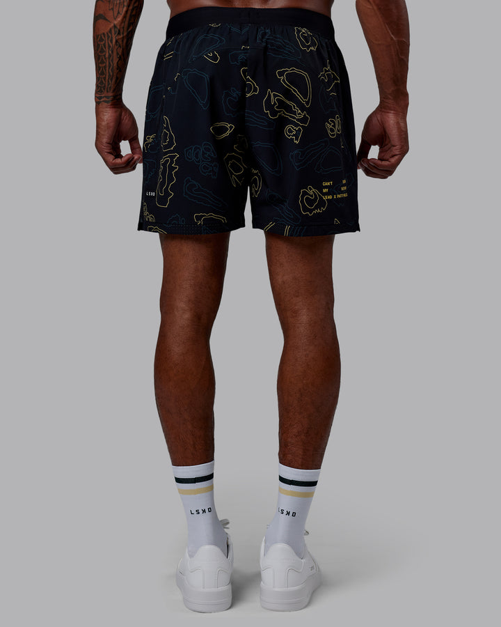 Man wearing Patty Mills Challenger 6&quot; Performance Shorts - Black-Vital Green
