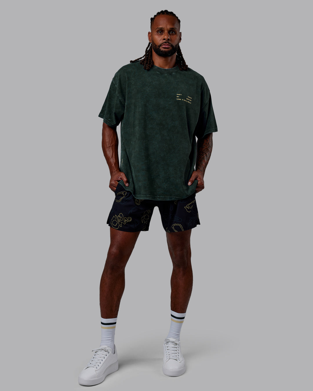 Man wearing Patty Mills Challenger 6&quot; Performance Shorts - Black-Vital Green