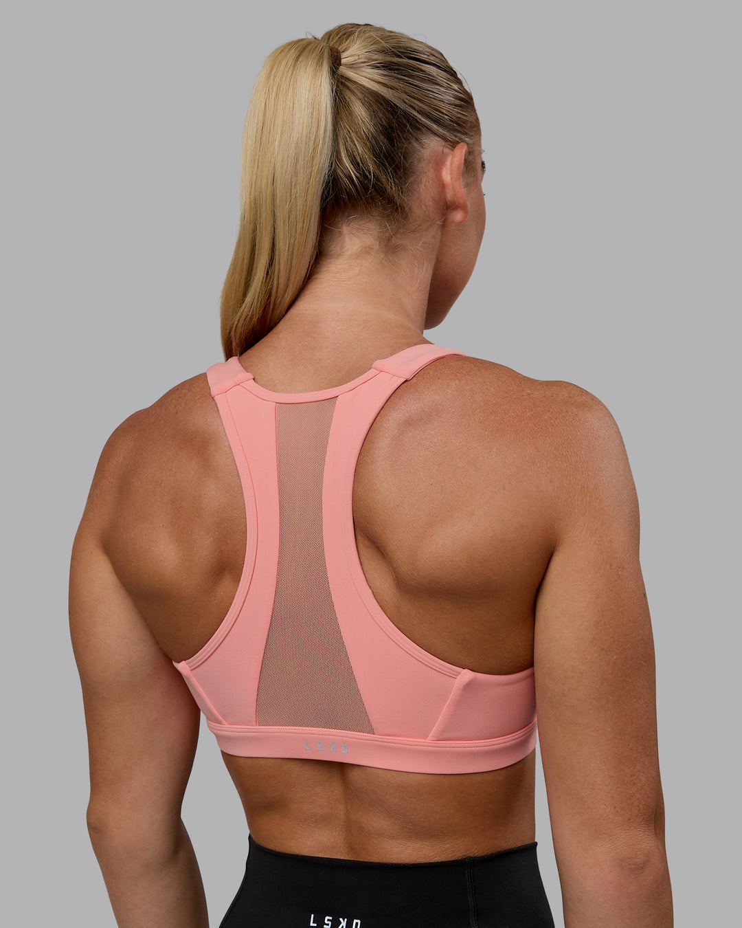 Woman wearing Precision Sports Bra - Murex Shell