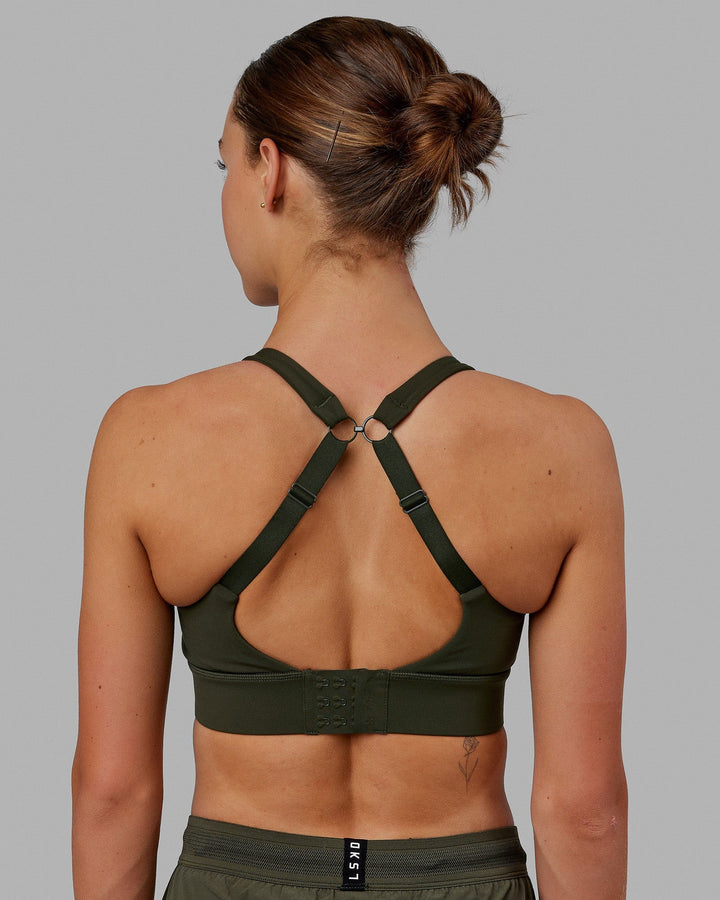 Woman wearing Propel Sports Bra - Forest Night
